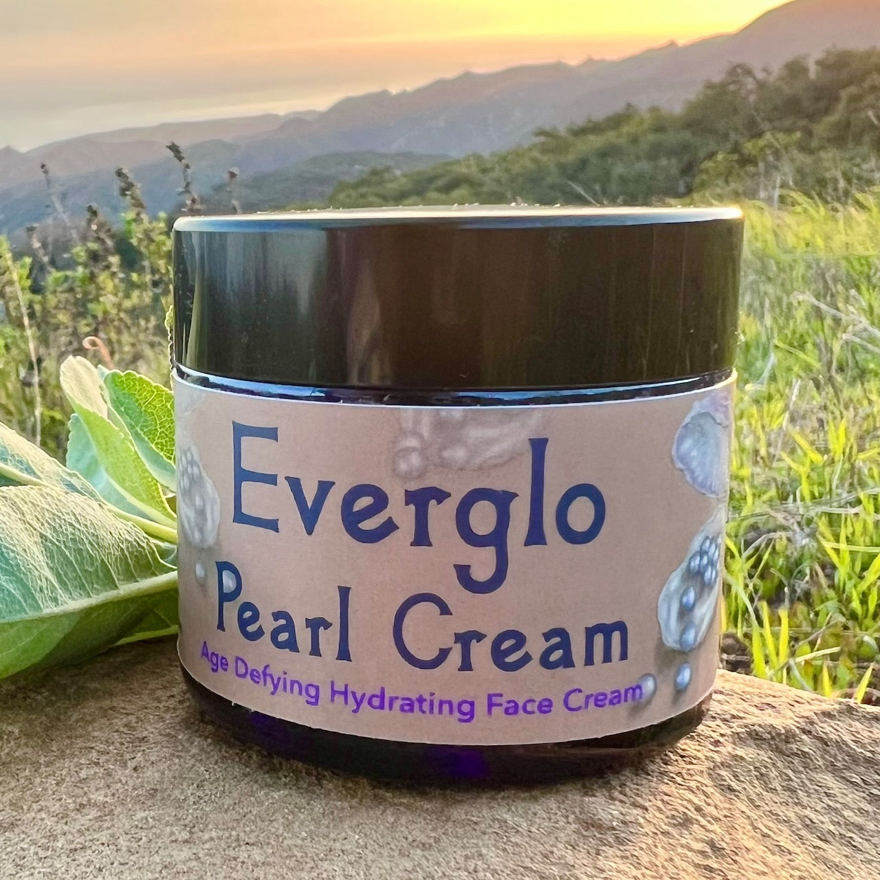 photograph of Everglo Pearl Cream Jar on rock with white sage