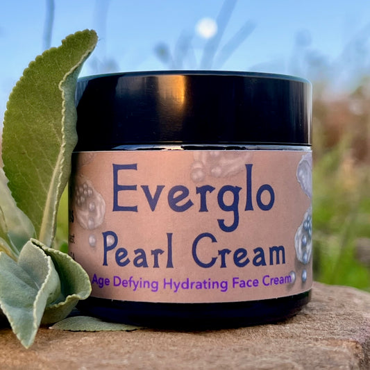 photograph of Everglo Pearl Cream Jar on rock with white sage