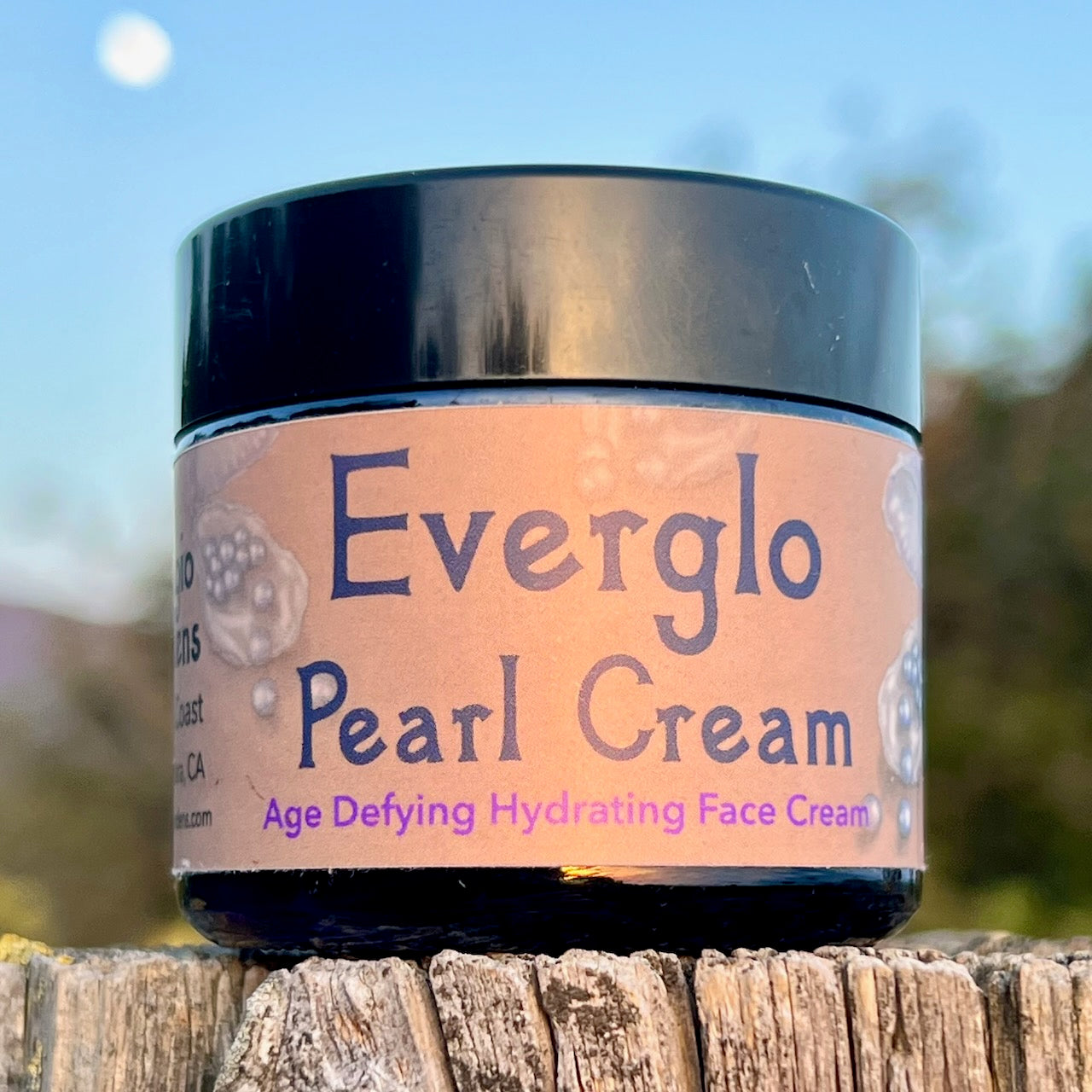 photograph of Everglo Pearl Cream Jar on wood post with moon in background