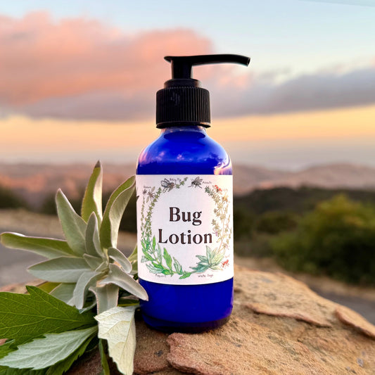 Photograph of Bug lotion 4 oz cobalt blue  jar with hand-drawn California mugwort and white sage label 